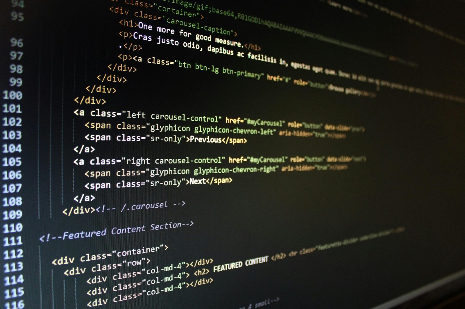 Close-up of HTML code displayed on a computer monitor, showcasing web development.